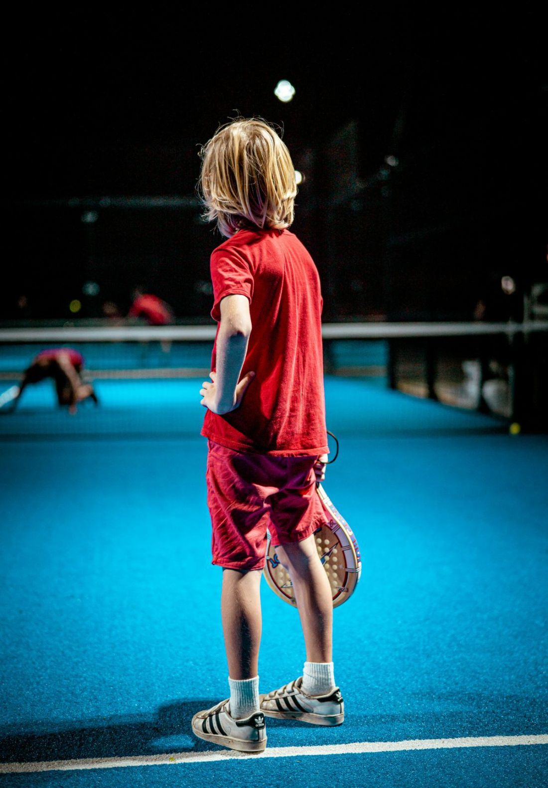 Kind met racket op de padelbaan tijdens een kids-feestje